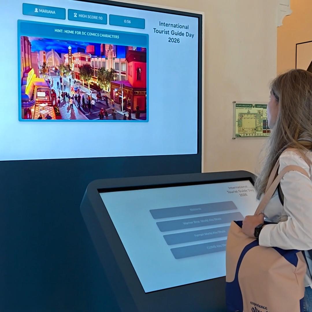 Multi-screen interactive UAE landmark guessing game display with custom branded interface for immersive event activation and digital tourism engagement.